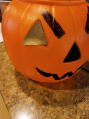 To get started, cut shapes out of your thin cardboard to fill in the indents of the face of your pumpkin.