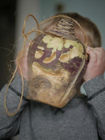 A Hop-tu-Naa turnip lantern held by a child on the Isle of Man. Lanterns like this were used throughout medieval times n the British Isles. (Hop-tu-Naa is the Isle of Man's celebration of Celtic Samhain.)
