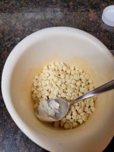 Place white chocolate chips in microwave-safe bowl with coconut oil.