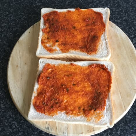 Red pesto is spread over both slices of bread