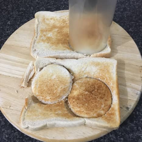 Circles are cut from the toast with a drinking glass