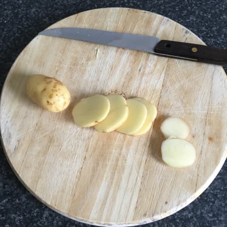 Slicing little potatoes for frying