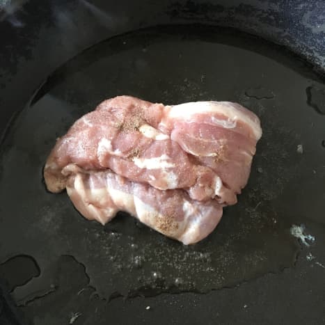 Seasoned pork leg steak is put on to fry