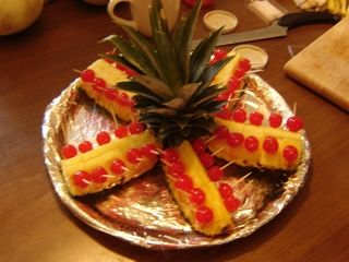 Lay out the pineapple top and the prepared pieces around it.