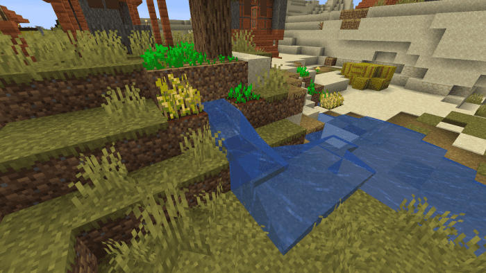 A small farm grows around a stream of water in a village.