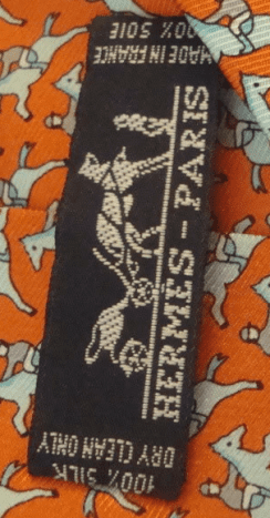 Uh Oh!  A figural tie with the words &quot;Herm&egrave;s-Paris&quot; written on it.  