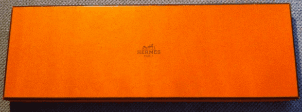 Real Herm&egrave;s tie boxes are a distinctive bright orange.  Fakes will be off-color and may not have the same font on the printing.  This one is legit!