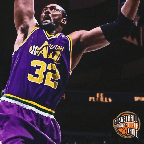 Karl Malone soaring high for a gigantic dunk.