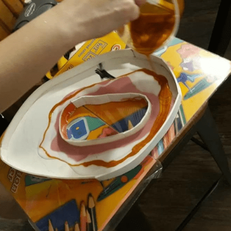 Pour the resin in a circular manner, layering the colors.