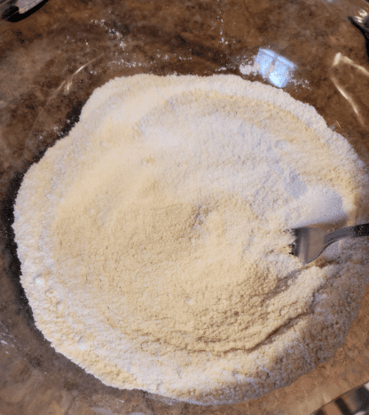 Combine sugars and flour in a large mixing bowl. Blend well.