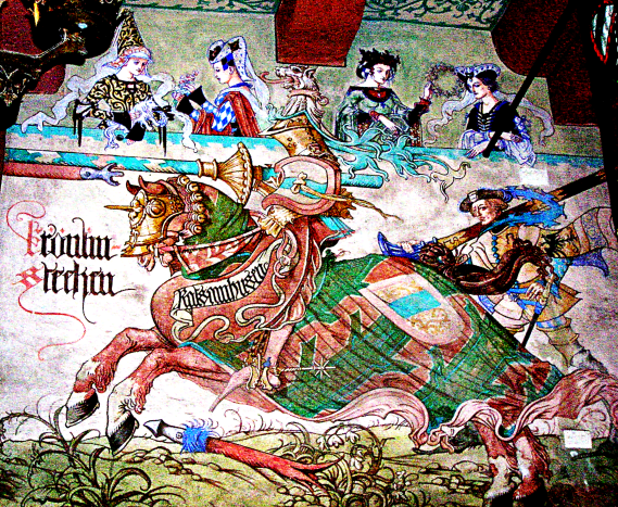 Mural depicting a medieval knight jousting. Please note the ribboned bow on the shield. This was likely given to the knight by one of the women in the balcony. This public demonstration of romantic intentions was &quot;wearing your heart on your sleeve.&quot;