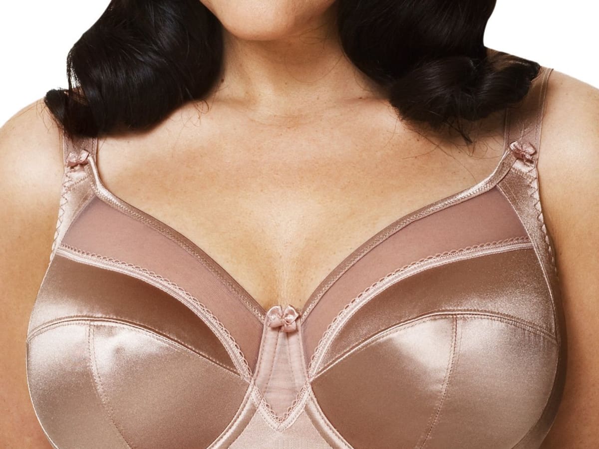 close up shot of voluptuous woman with large breast holding a bar