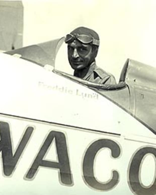 Freddie Lund in his Waco biplane as test pilot for the company.