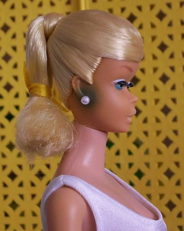 This is green ear caused by the metal from  Barbie's earring that were left in her ears.