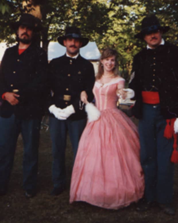 This was taken in Nova, OH, in July 1993. The first reenactment I ever attended in dress. The ballgown was bought at a theater sale for, I think, $15. With me are the gallant lads of the 7th Ohio Volunteer Infantry.