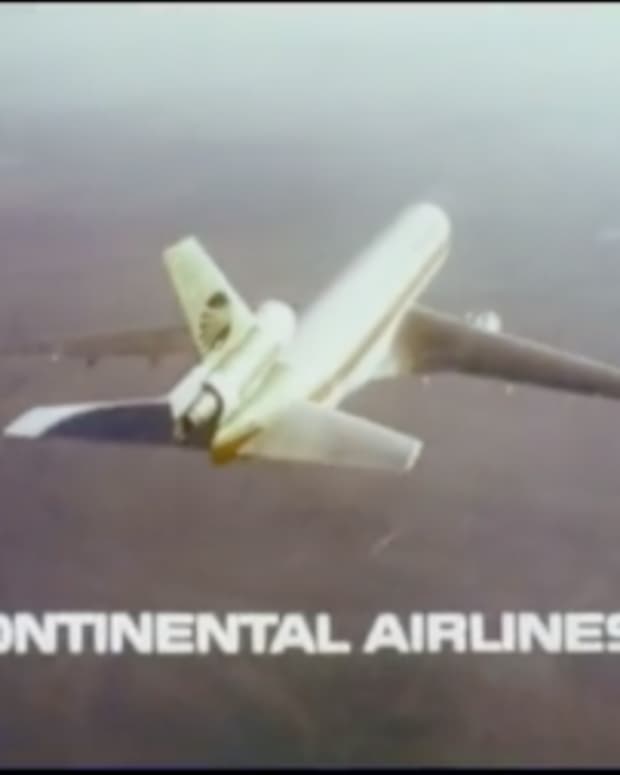 A vintage 1970s shot of a Continental Airlines Plane flying in the sky with their logo underneath