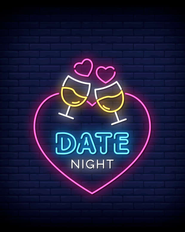 Heart-shaped neon sign that says "Date Night" in the middle