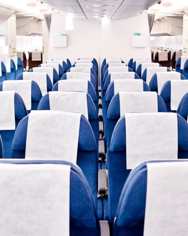 A spacious empty airplane cabin with rows and rows of seats