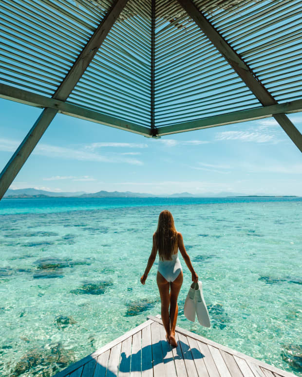 A woman overlooks the crystal-clear waters of the Maldives