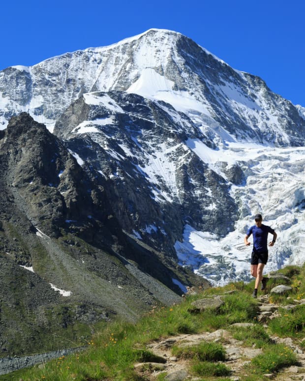 A lone jogger runs along an Alpine trail in Switzerland