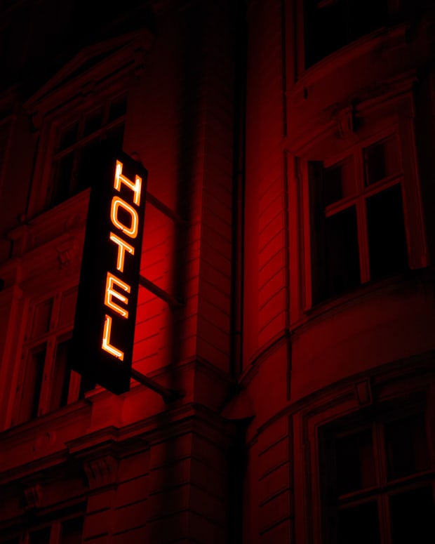 Red and yellow lighting, neon sign saying HOTEL
