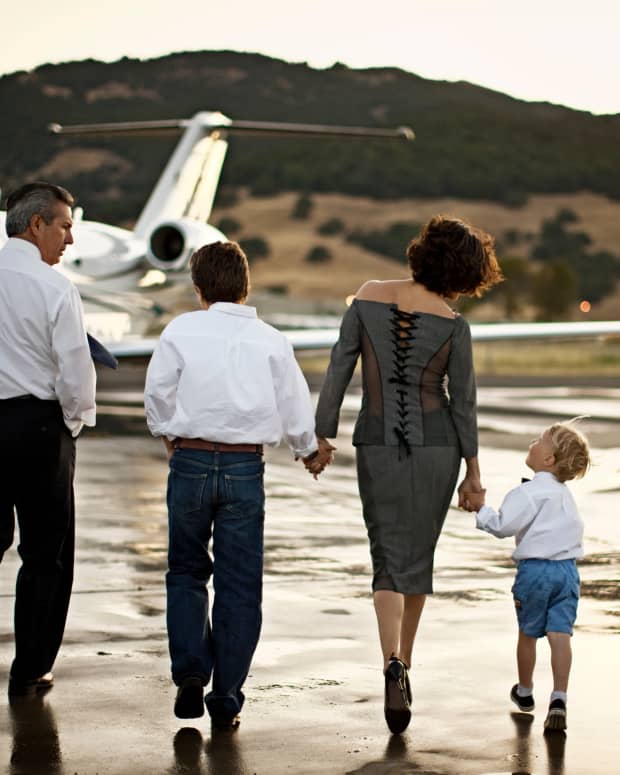 A mother and child walking towards a private jet