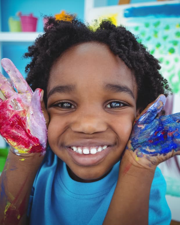 little kid with paint on hands