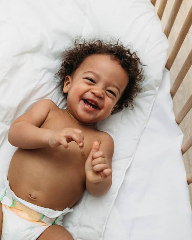 baby laughing in crib