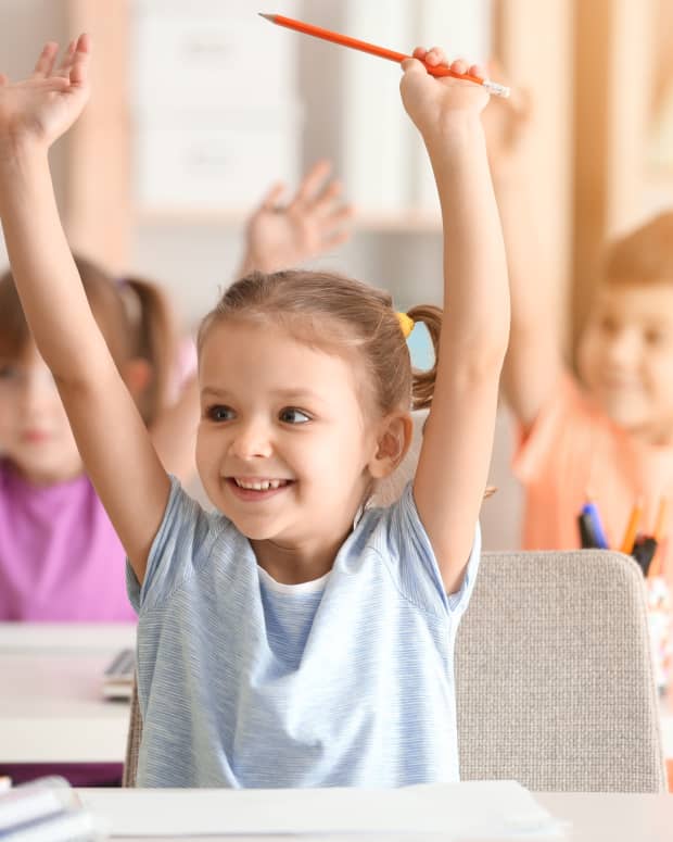 kids raising hands in class