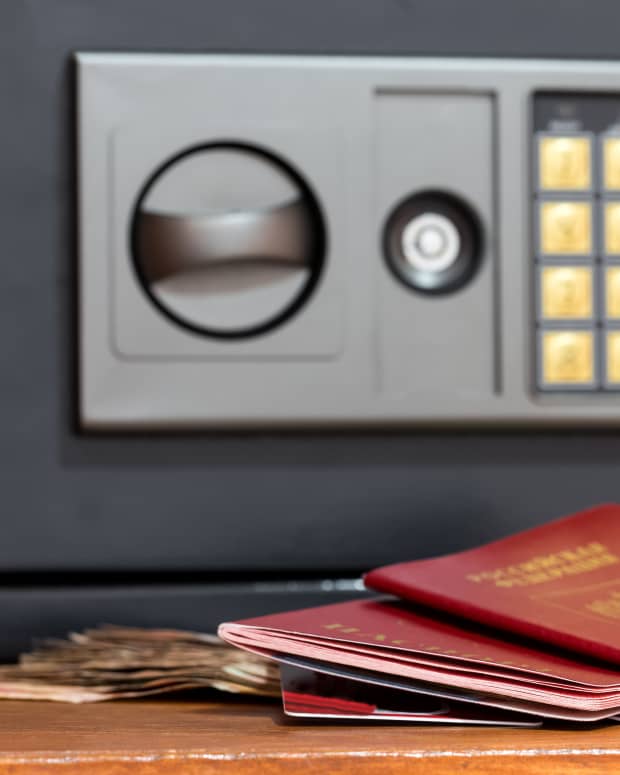 Passports and cash in front of a hotel room safe