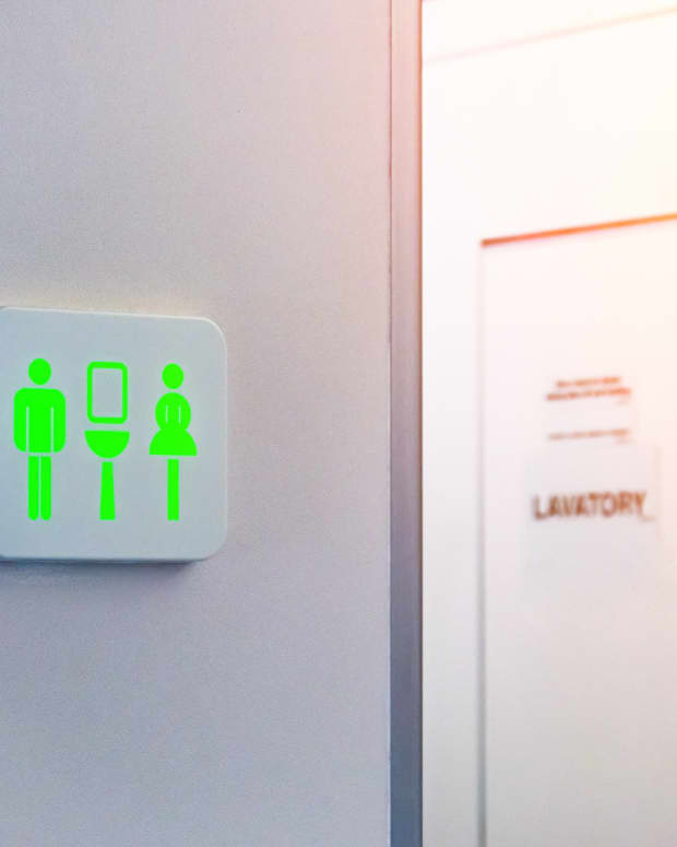 Lit green unoccupied sign of an airplane lavatory