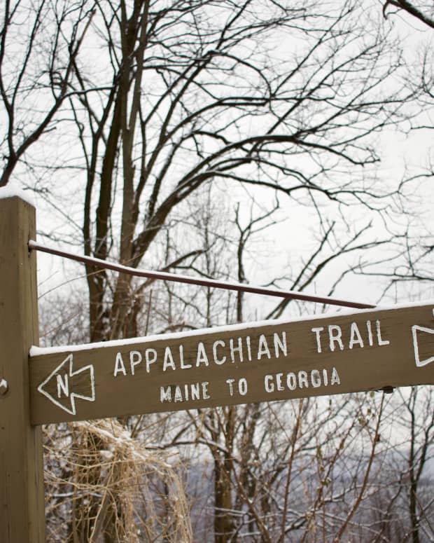 Wooden sign for the Appalachian trail in Pennsylvania, pointing north and south to the end destinations in Maine and Georgia