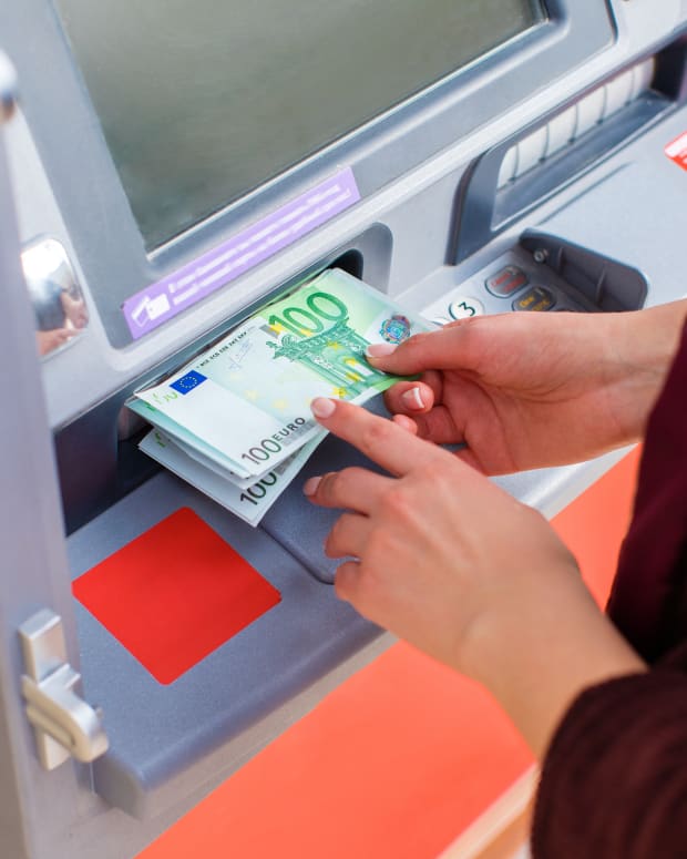 Woman withdrawing Euros from an ATM