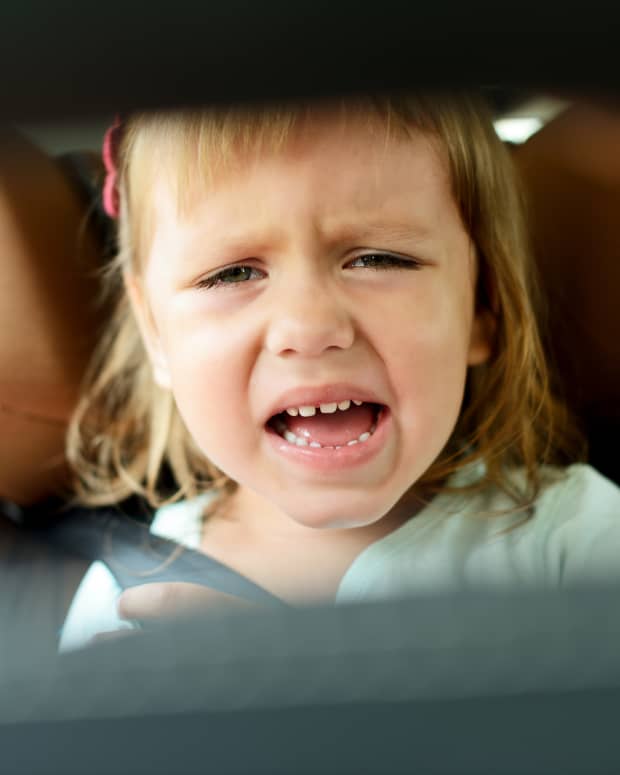 angry toddler girl in car