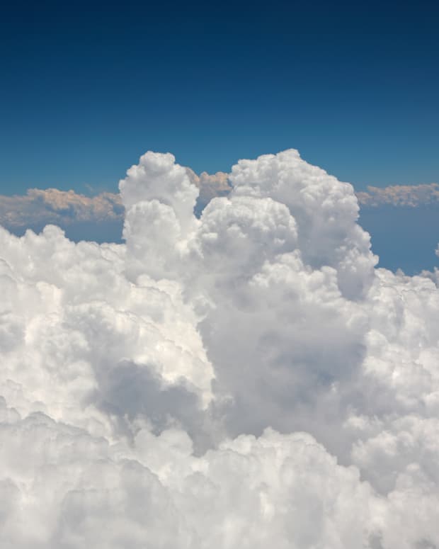 White cumulus clouds seen from an airplane window