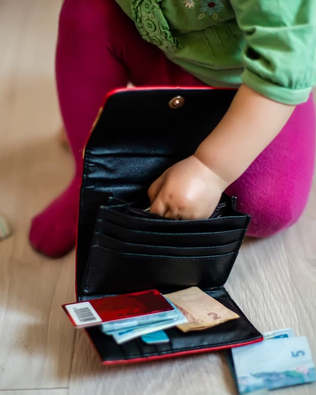 toddler with purse and money