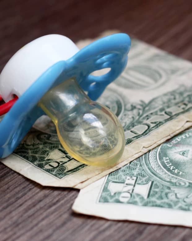 a pacifier with dollar bills