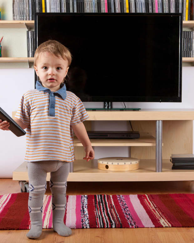 toddler holding the remote