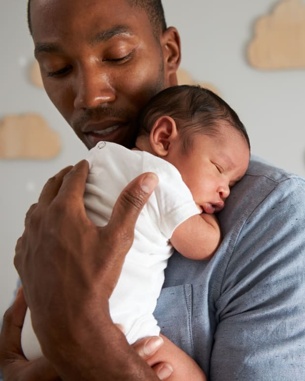 man holding a newborn baby