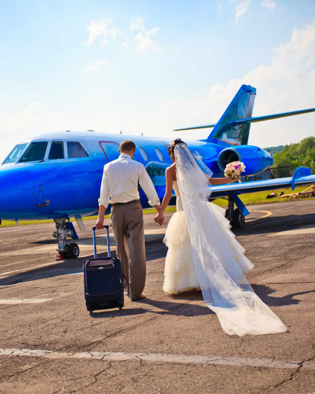 bride and groom walking to airplane