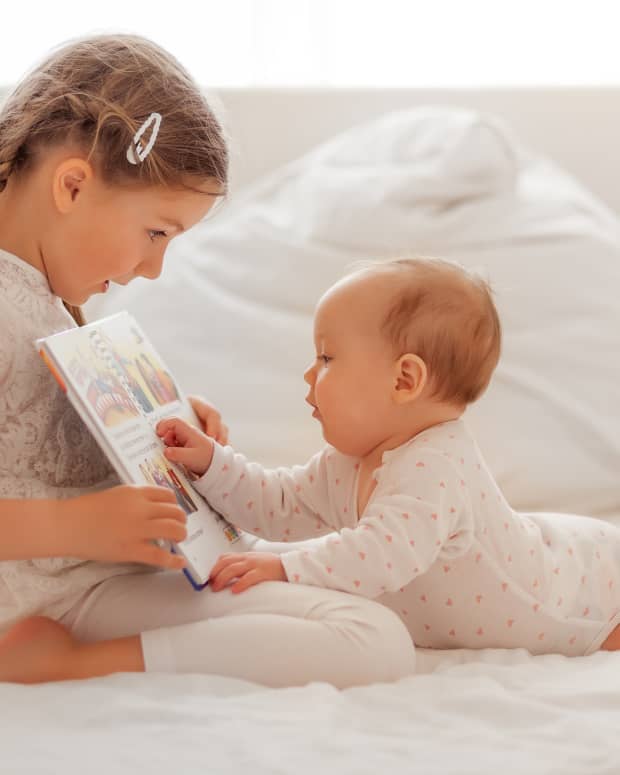 girl reading to little sister