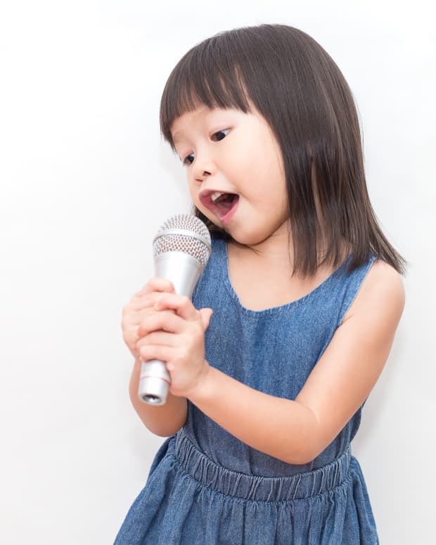 little girl singing into microphone