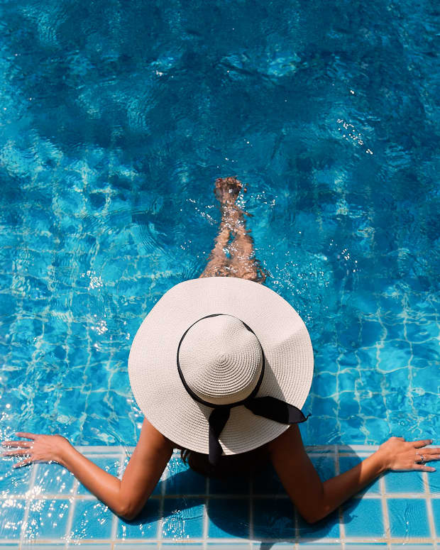 A woman relaxing in a quiet swimming pool.
