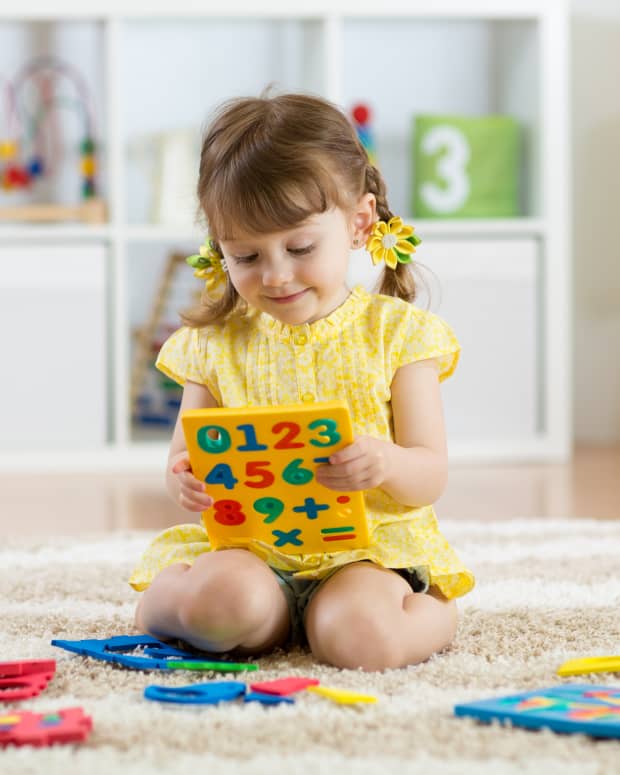 little girl playing with counting puzzle
