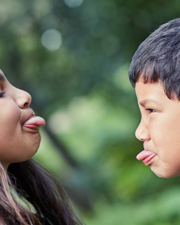 siblings sticking their tongues out at each other