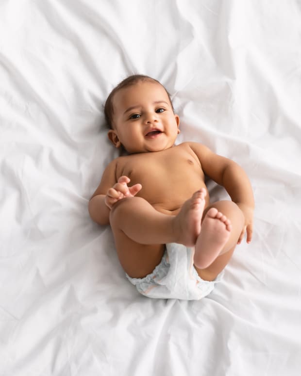 baby laying on a white sheet
