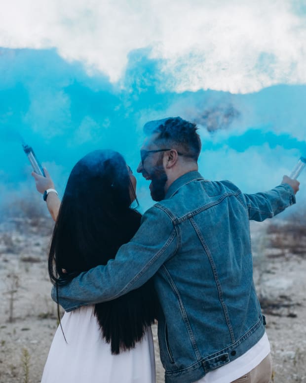 gender reveal with blue smoke
