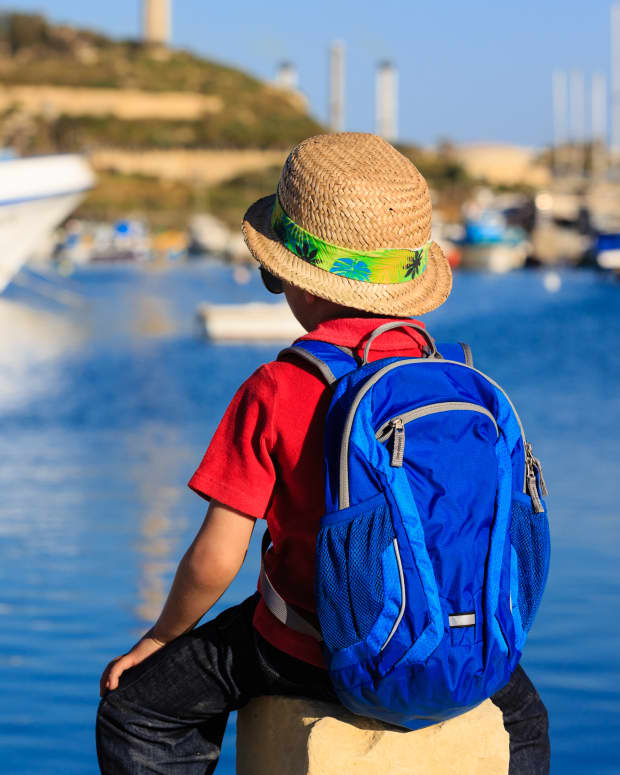 little boy traveling with backpack