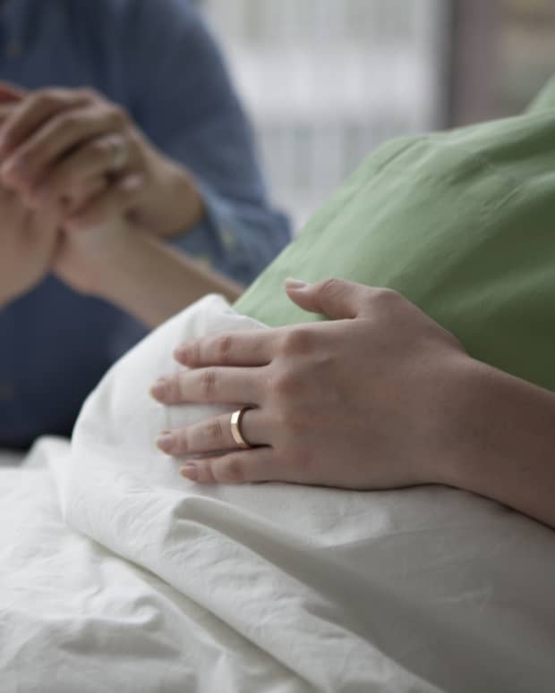 man and woman holding hands while woman is in labor