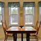 Dining area looks out over backyard. Privacy curtains are not really necessary, but there are roll-up shades to block sun when needed.